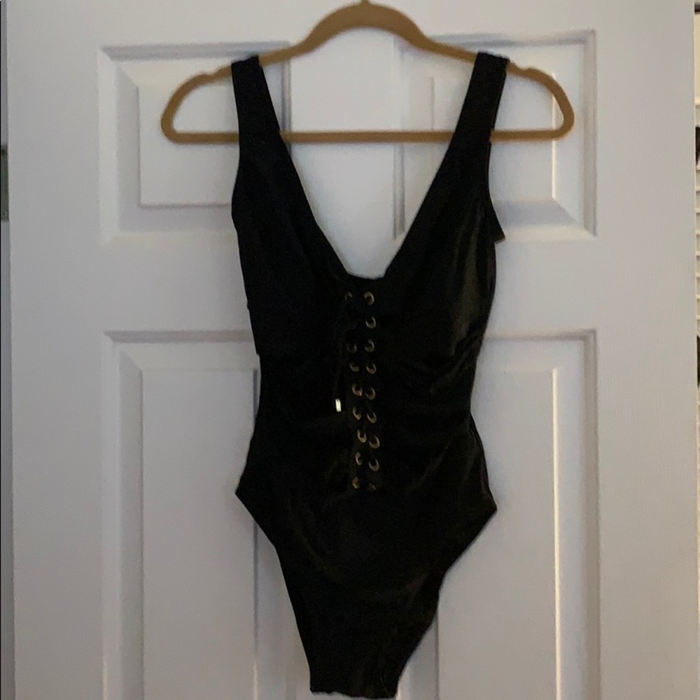 Black one piece bathing suit with gold accents